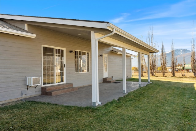 view of patio with a mountain view and a wall mounted AC