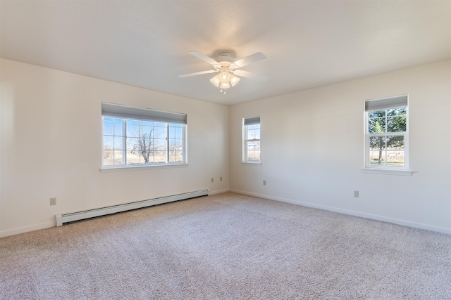 carpeted spare room with ceiling fan and a baseboard radiator