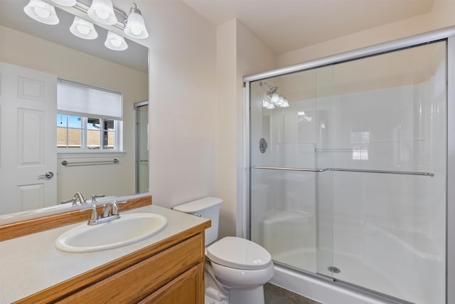 bathroom with walk in shower, vanity, and toilet