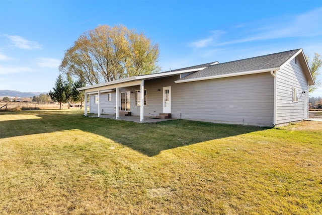 single story home with a front yard and a patio area