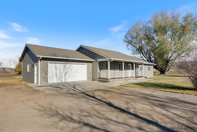 ranch-style home with a front lawn, a garage, and covered porch