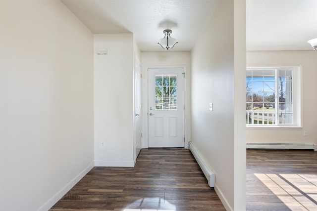 doorway featuring dark hardwood / wood-style floors and a baseboard heating unit