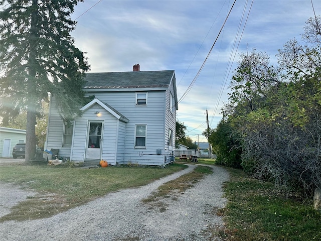 824 8th St W, Kalispell, MT 59901 - view of front facade with a chimney and driveway
