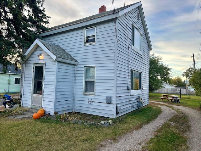 824 8th St W, Kalispell, MT 59901 - view of property exterior with a chimney