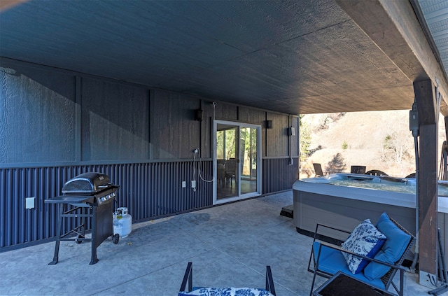 view of patio / terrace featuring area for grilling and a hot tub