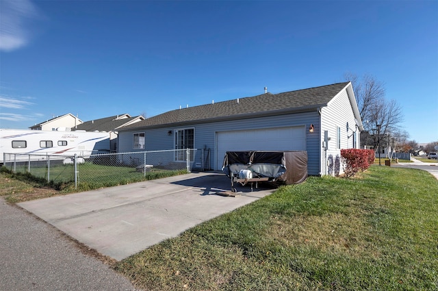 rear view of house with a garage and a lawn