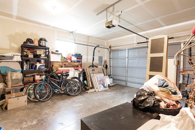 garage with a garage door opener and electric panel