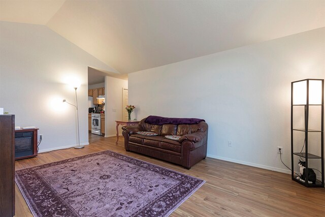 living room with wood-type flooring and vaulted ceiling