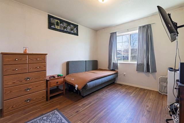 bedroom featuring dark hardwood / wood-style flooring