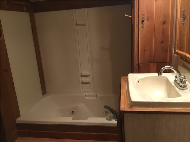 bathroom with a washtub and sink