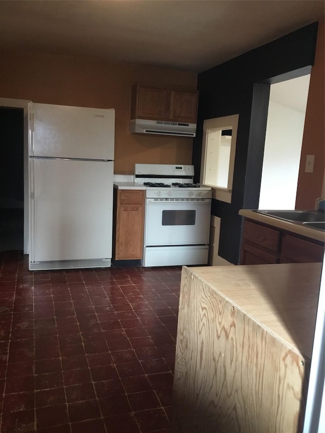 kitchen with white appliances and extractor fan