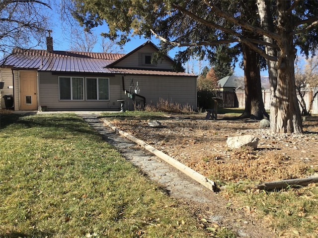 back of house with a lawn