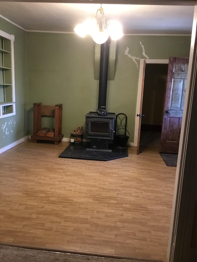 living room with light hardwood / wood-style floors, a wood stove, and crown molding