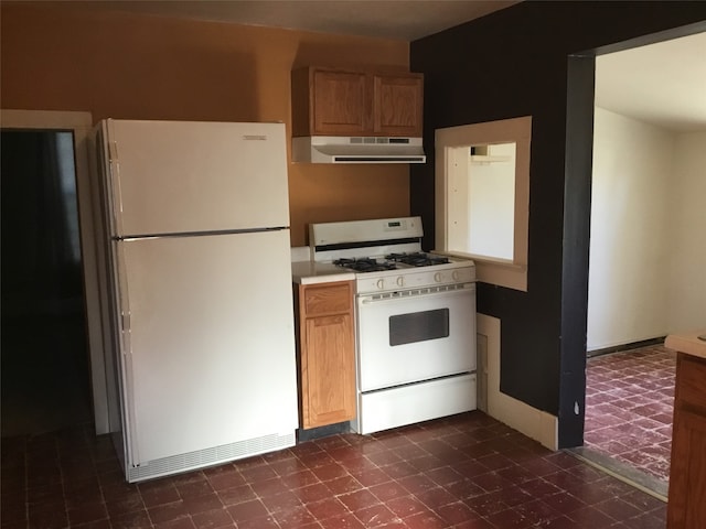 kitchen with white appliances and range hood