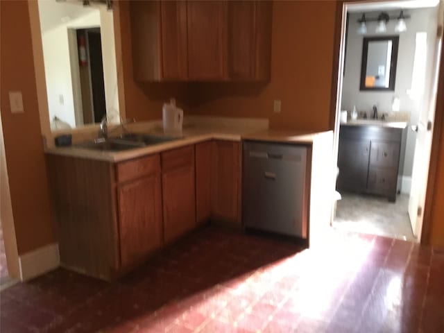 kitchen featuring dark hardwood / wood-style flooring, dishwasher, and sink