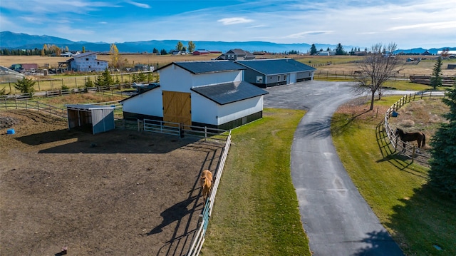 drone / aerial view featuring a mountain view and a rural view