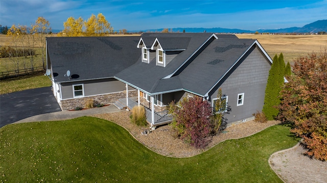 exterior space with a mountain view, a yard, and covered porch