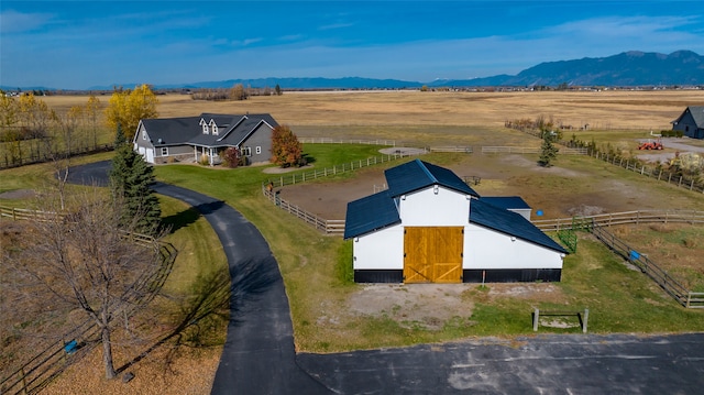 drone / aerial view with a mountain view and a rural view