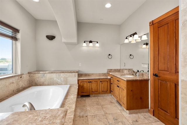 bathroom with vanity and tiled tub