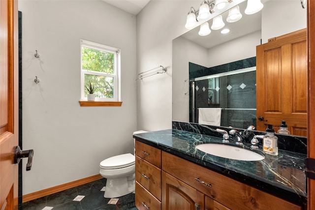 bathroom with a shower with shower door, vanity, toilet, and tile patterned flooring