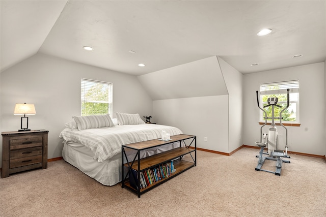 carpeted bedroom with lofted ceiling