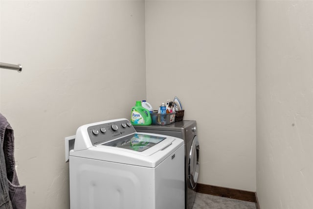 clothes washing area featuring washing machine and clothes dryer