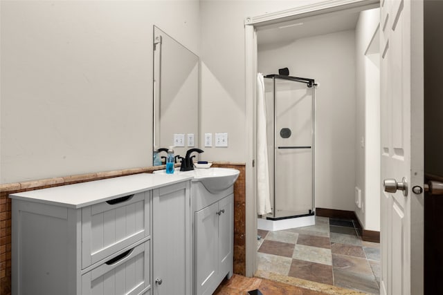 bathroom with vanity and a shower with door