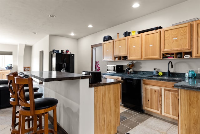 kitchen with black appliances, sink, light tile patterned floors, and a center island