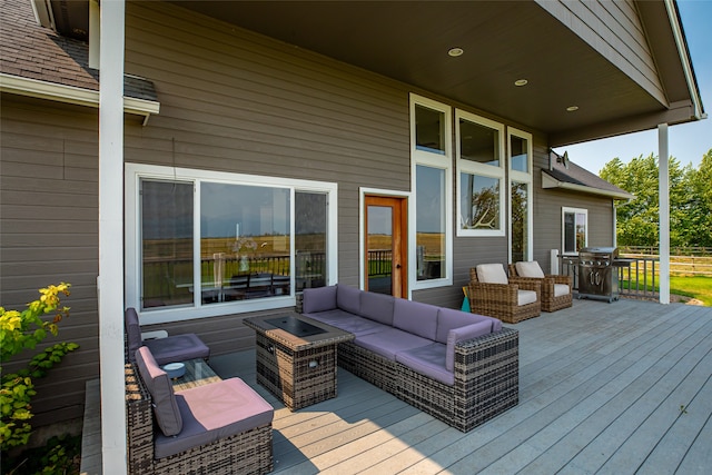 deck with an outdoor living space with a fire pit