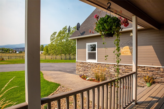 view of property exterior with a lawn and a mountain view