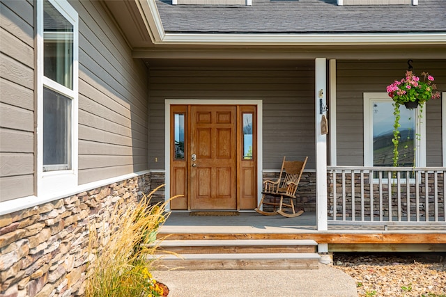 doorway to property featuring covered porch