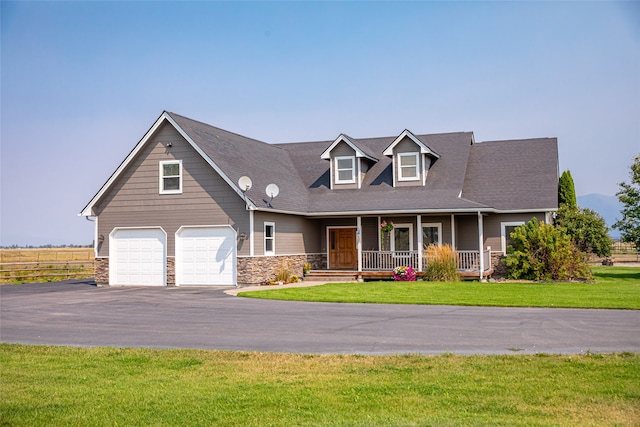 cape cod house with a porch, a front lawn, and a garage