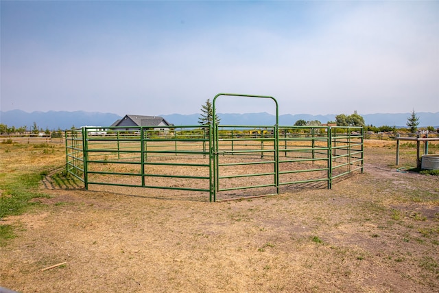 view of gate with a mountain view and a rural view