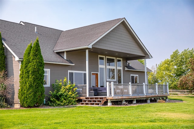 back of house featuring a deck and a yard