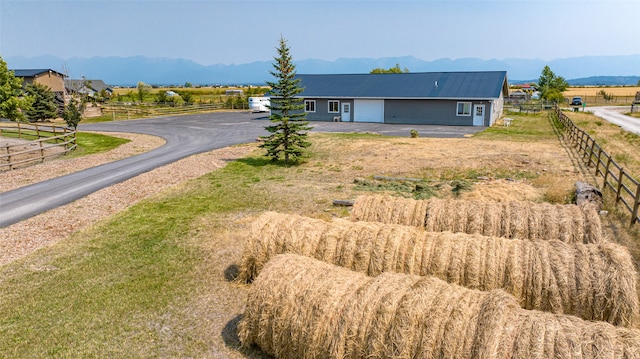 view of front of house featuring a mountain view and a rural view