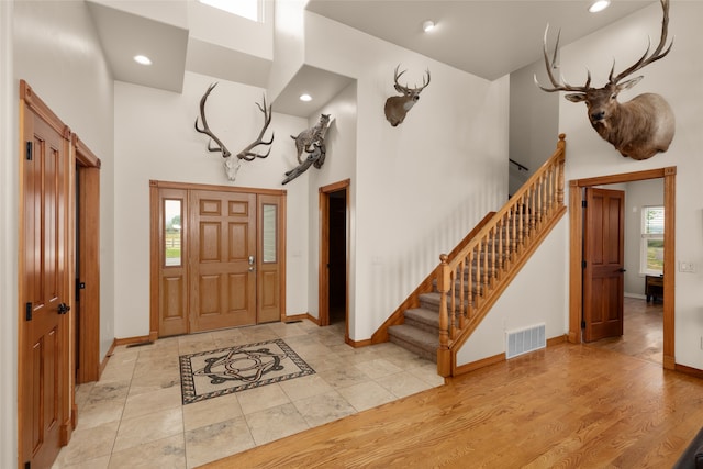 foyer with a high ceiling and light wood-type flooring