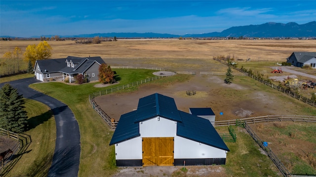 birds eye view of property with a mountain view and a rural view