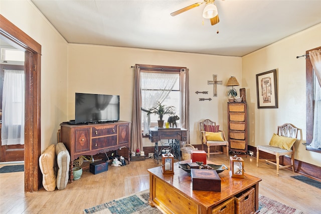 living room featuring light wood-type flooring and ceiling fan