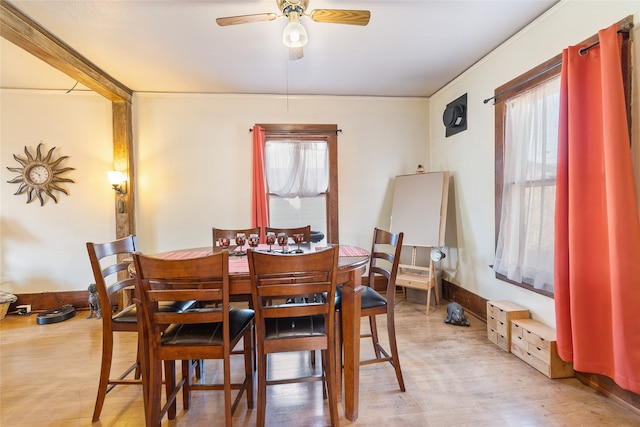 dining area with light hardwood / wood-style floors, ceiling fan, and plenty of natural light