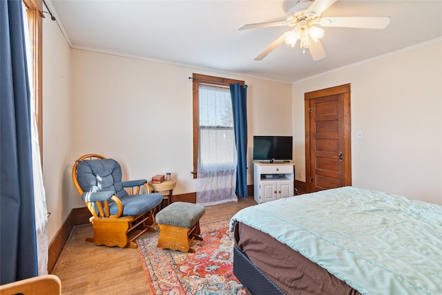 bedroom featuring ornamental molding, light wood-type flooring, and ceiling fan