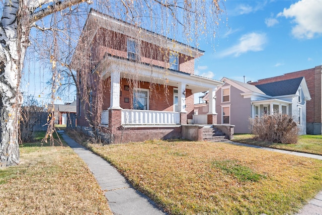 view of front of house with a porch and a front lawn