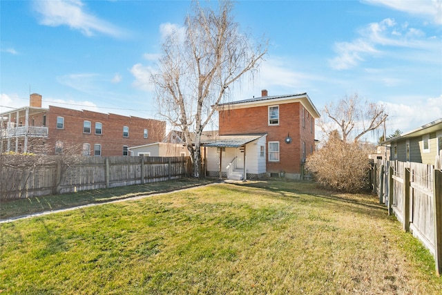 rear view of house featuring a lawn