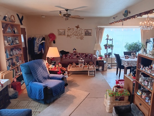 living room featuring ceiling fan with notable chandelier