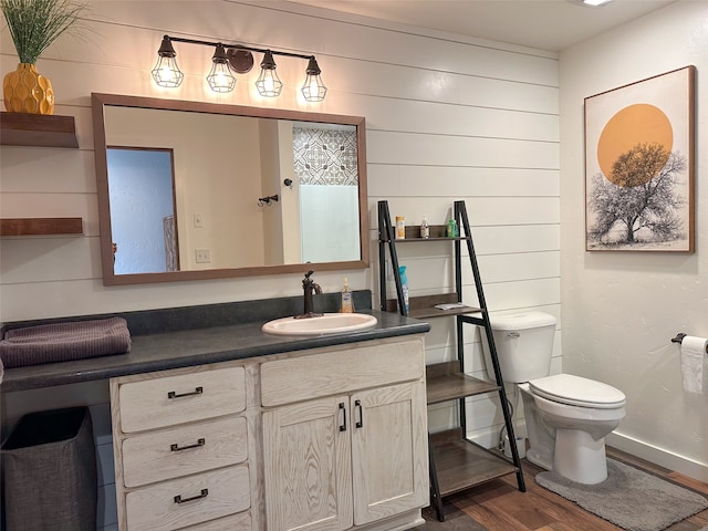 bathroom featuring hardwood / wood-style flooring, vanity, and toilet