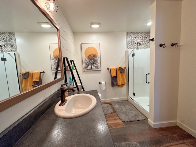 bathroom with walk in shower, vanity, and toilet