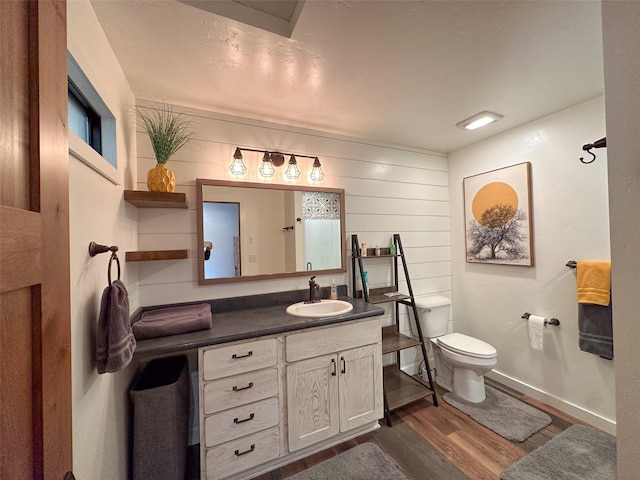 4895 Mt Highway 200, Thompson Falls, MT 59873 - bathroom featuring wood finished floors, toilet, vanity, and baseboards
