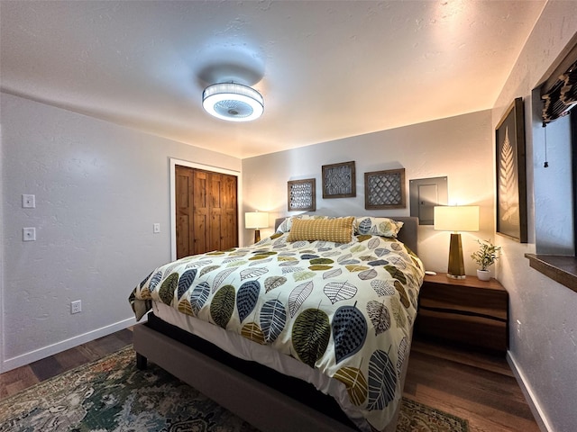 4895 Mt Highway 200, Thompson Falls, MT 59873 - bedroom featuring baseboards, wood finished floors, a closet, and a textured wall