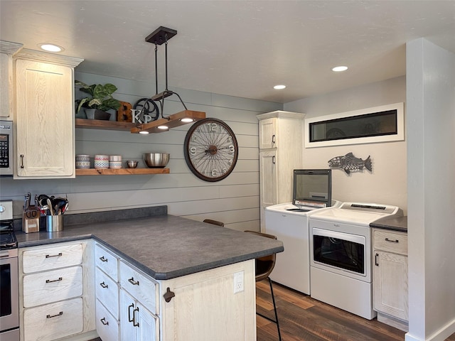 4895 Mt Highway 200, Thompson Falls, MT 59873 - kitchen with independent washer and dryer, dark countertops, dark wood-style floors, stainless steel range, and recessed lighting