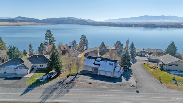 drone / aerial view with a water and mountain view