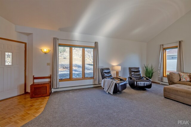 living room with a baseboard radiator, a wealth of natural light, and vaulted ceiling